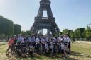 Fundraising cyclists for Kids Inspire arrive at the finish life of the Eiffel Tower, Paris