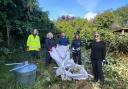 The UK Power Networks team at work clearing the overgrown garden.