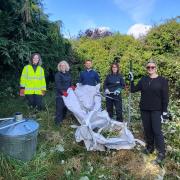 The UK Power Networks team at work clearing the overgrown garden.