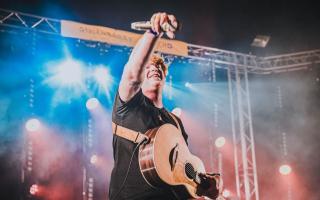 Jack Shepherd performing his tribute show 'The Ed Sheeran Experience' on stage with a full live band.