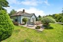 A bungalow in an elevated position overlooking the River Bure is on the market for offers over £700,000