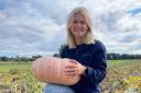 Emily Wheaton of Akenham Hall Farm in Ipswich with one of the farm's pumpkins