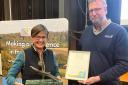 Louise Bond, who manages Bedingham Hall Farm near Bungay, is presented with the Ian MacNicol Trophy by Rob Holland, from sponsor Anglian Water