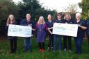 Members from the Sutton and Mepal District Poppy Appeal and the Elysian Riding for the Disabled Association collecting their cheques from Nellie's.