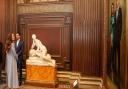 Kate, the Duchess of Cambridge with the official portrait of her and her husband, Prince William