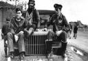 Captain Walker L. Boone, Flight Officer Manuel S. Martinez and Flight Officer Gerry E. Brasher, pilots of the American 78th Fighter Group, sit on the bonnet of a Dodge WC (weapons carrier) at Duxford air base, 1943. Picture: IWM FRE 282