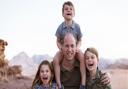 A smiling William is shown with his arms around Prince George, eight, and Princess Charlotte, seven, while four-year-old Prince Louis sits on his shoulders. The Duke and Duchess of Cambridge will be at County Day, Newmarket, on June 23.