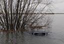 An Audi bobs in the water after becoming stuck in floods on Welney Wash Road