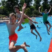 A group of friends leap into the Jesus Green Lido in Cambridge on Monday, July 18, when temperatures reached 36C