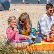 A family enjoying Great Yarmouth Beach in Norfolk.