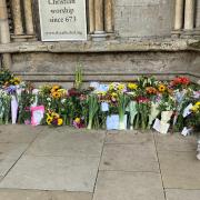 Floral tributes are being left outside Ely Cathedral.