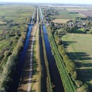 Work to install a temporary flood barrier on the A1101 Welney Wash Road will mean there will be two-way traffic lights and a full road closure over the next few months.