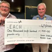 Soham shop manager Darren Martin (left) receiving a cheque for £1,700 from Soham and Staploe Rotary Club president Stuart Cavanagh.