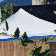 A police tent in one of the gardens in John Amner Close, off Lynn Road, in Ely.