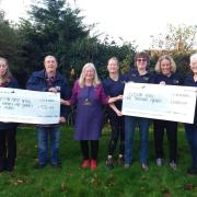 Members from the Sutton and Mepal District Poppy Appeal and the Elysian Riding for the Disabled Association collecting their cheques from Nellie's.