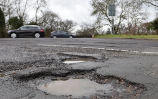 Stock image of a pothole.